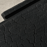 Macro close-up of charred Australian hardwood Shou Sugi Ban cladding showing deep alligator-skin char texture.